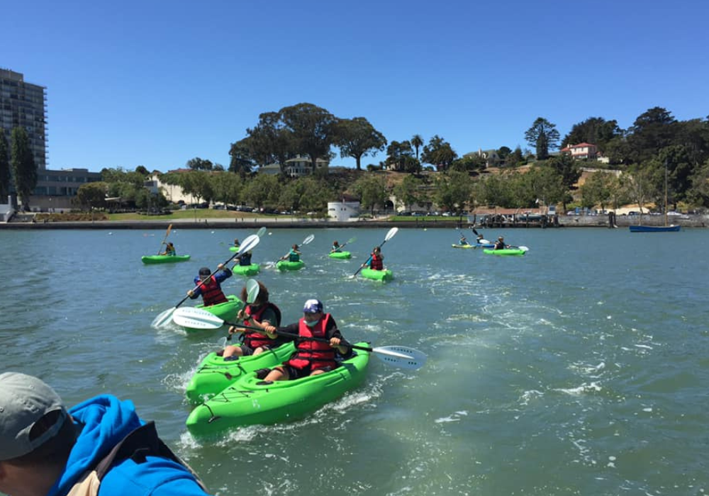 Scouts Kayaking in Green Kayaks