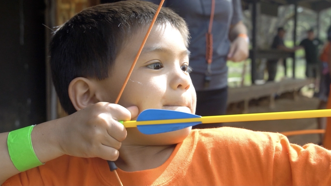 Cub Scout with bow and arrow